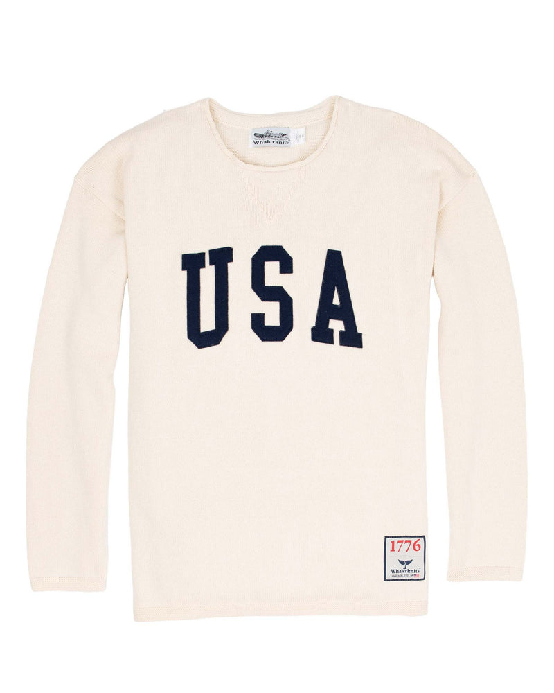 Whalerknits USA HOMETOWN Sweater: Natural sweater laid flat with large navy USA lettering and a small hem patch. #Color_Natural