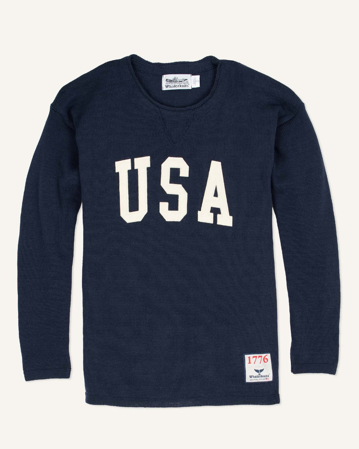 Whalerknits USA HOMETOWN Sweater: Navy sweater laid flat with large natural-colored USA lettering and a small hem patch. #Color_Navy