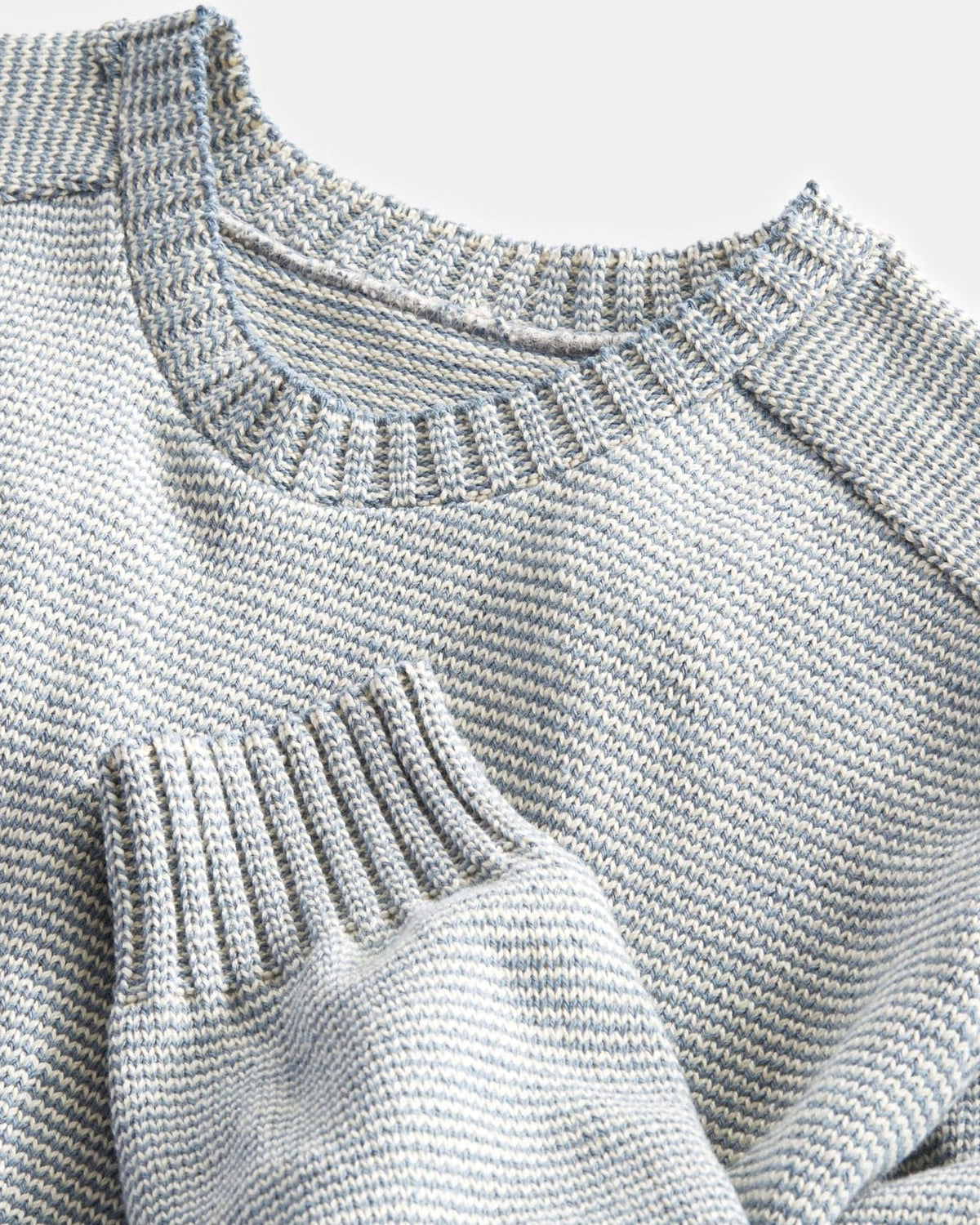 Whalerknits Westport Crewneck Saddle Shoulder Pullover: Close-up of the light blue and natural neckline, sleeve cuff and knit stitches.