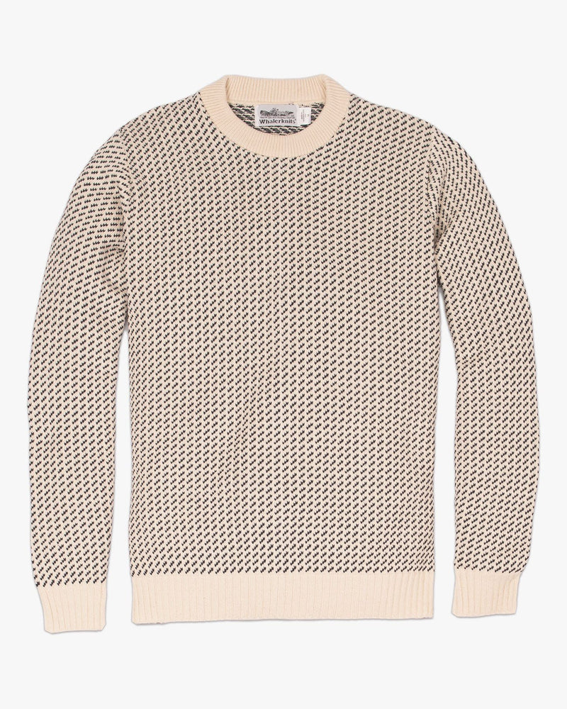 Whalerknits Sakonnet Birdseye Crewneck Pullover: Natural sweater with navy birdseye pattern laid flat, showing solid ribbed collar, cuffs and hem.
