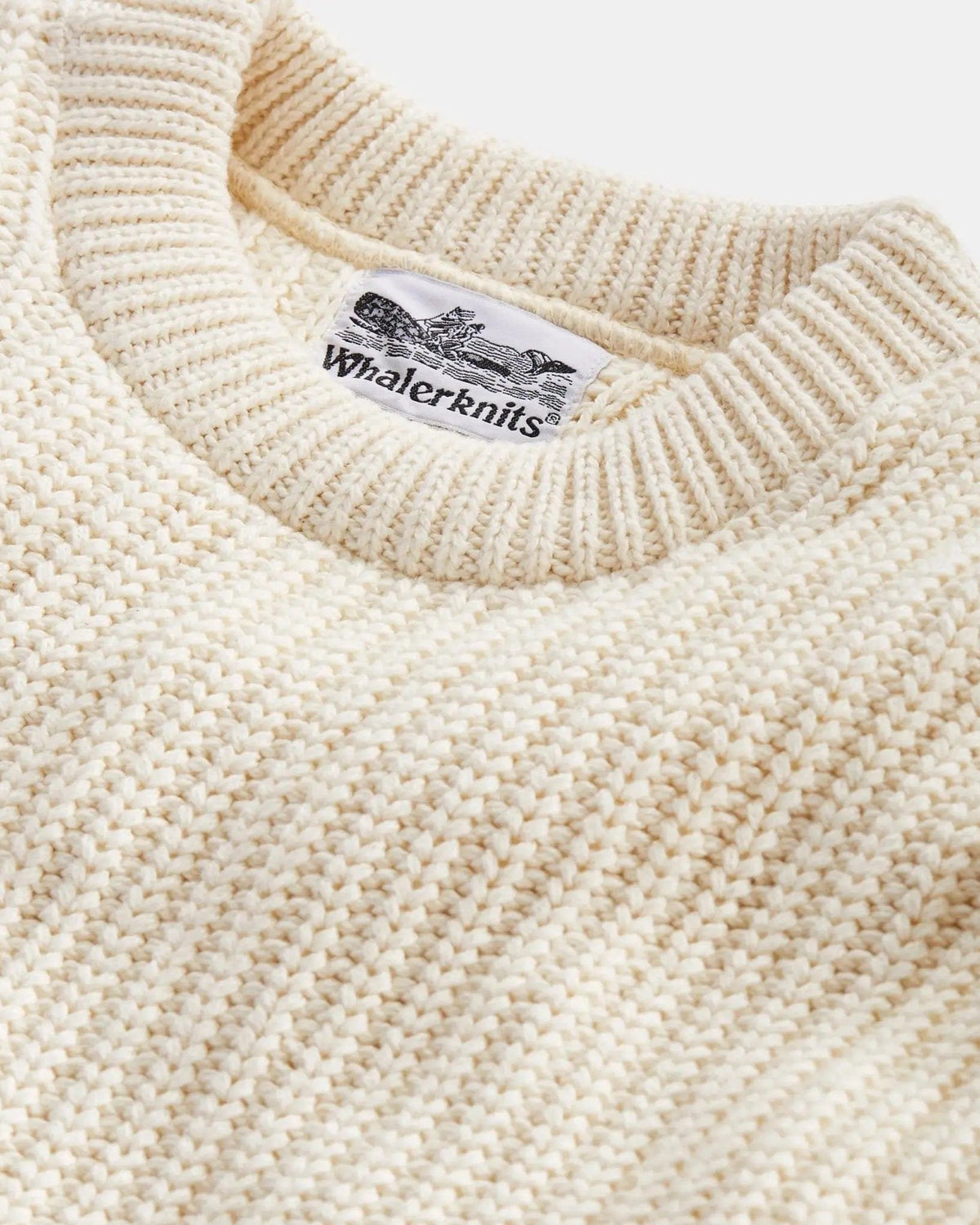 Whalerknits Newport Shaker Knit Crewneck Sweater: Close-up of the natural-colored ribbed crew neckline, shaker knit and Whalerknits label.