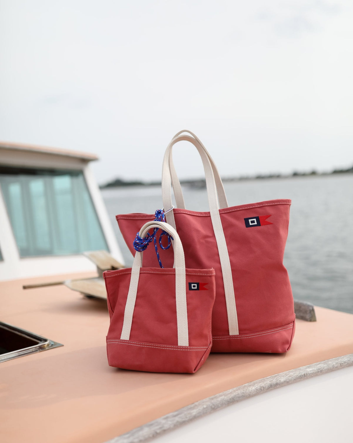 Signal Medium and Mini Totes on the cabin roof of the red lobster boat