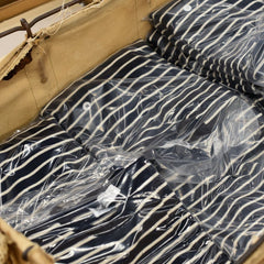 Finished Whalerknits striped sweaters in a Steele canvas hamper at the Fall River mill