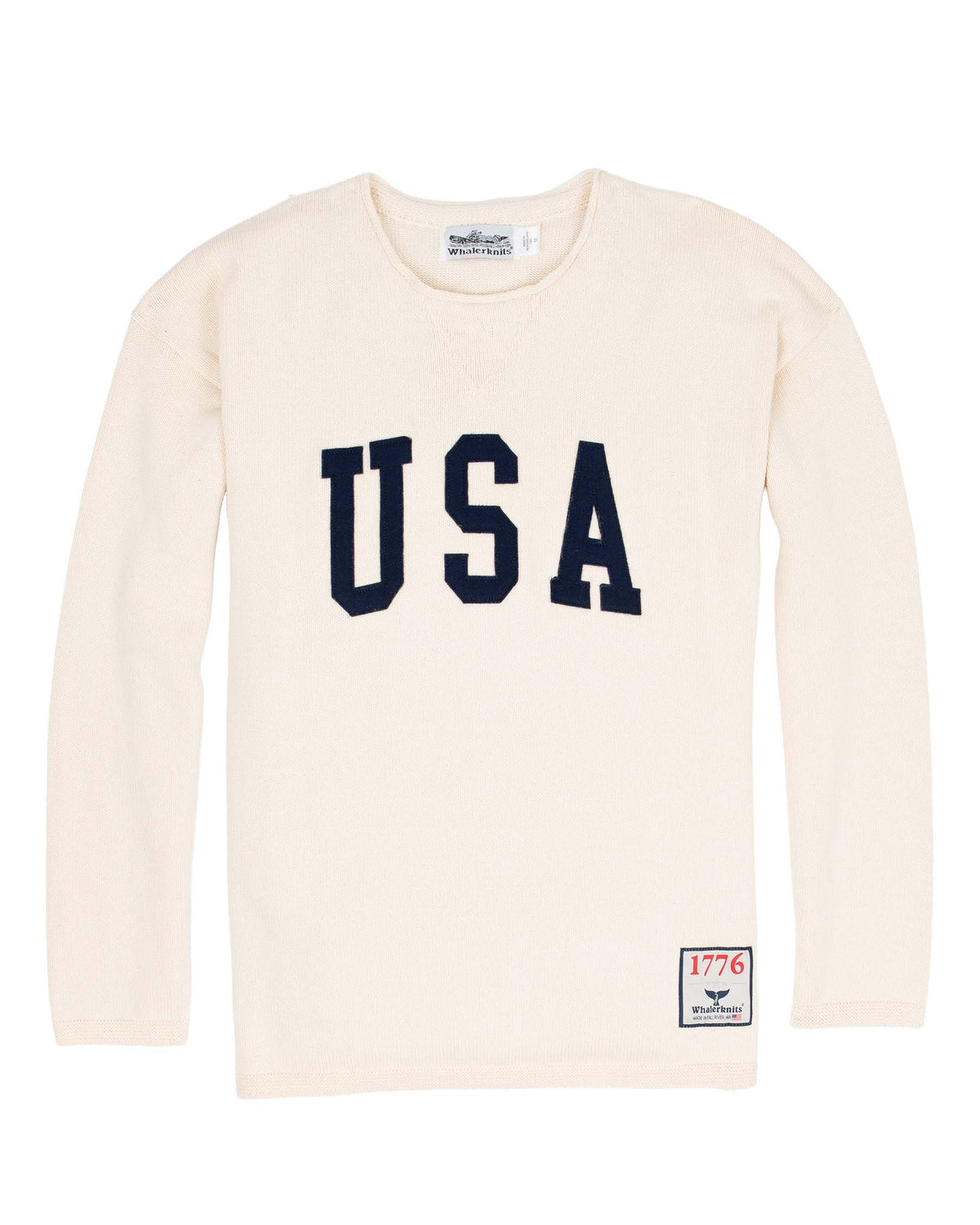 Whalerknits USA HOMETOWN Sweater: Natural sweater laid flat with large navy USA lettering and a small hem patch. #Color_Natural
