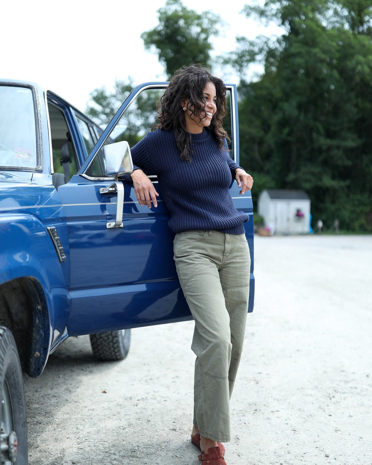 Whalerknits Newport Shaker Knit Crewneck Sweater: A woman in navy rests her arm on an open blue vehicle door.
