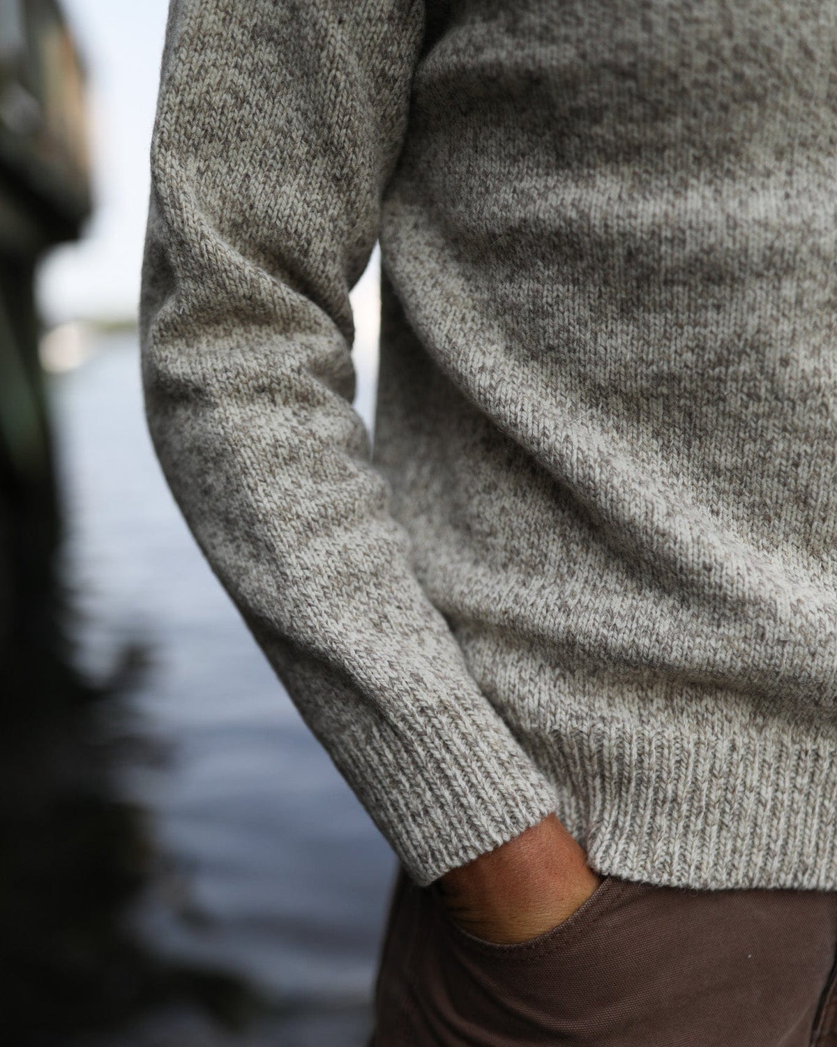 Whalerknits Wellfleet Classic Crewneck Jersey - Wool Blend: Close-up of the heathered sleeve, ribbed cuff and hem beside a trouser pocket.