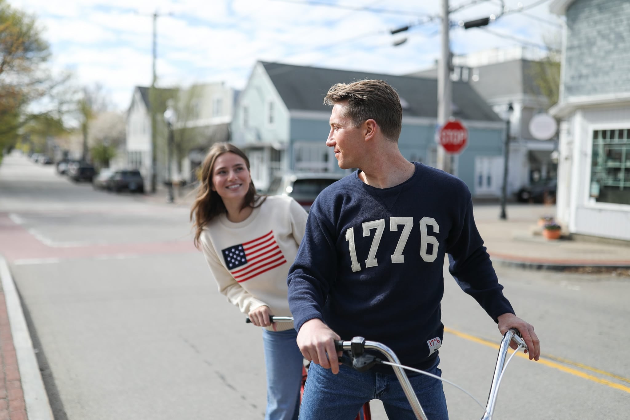 Couple riding bikes on a New England main street