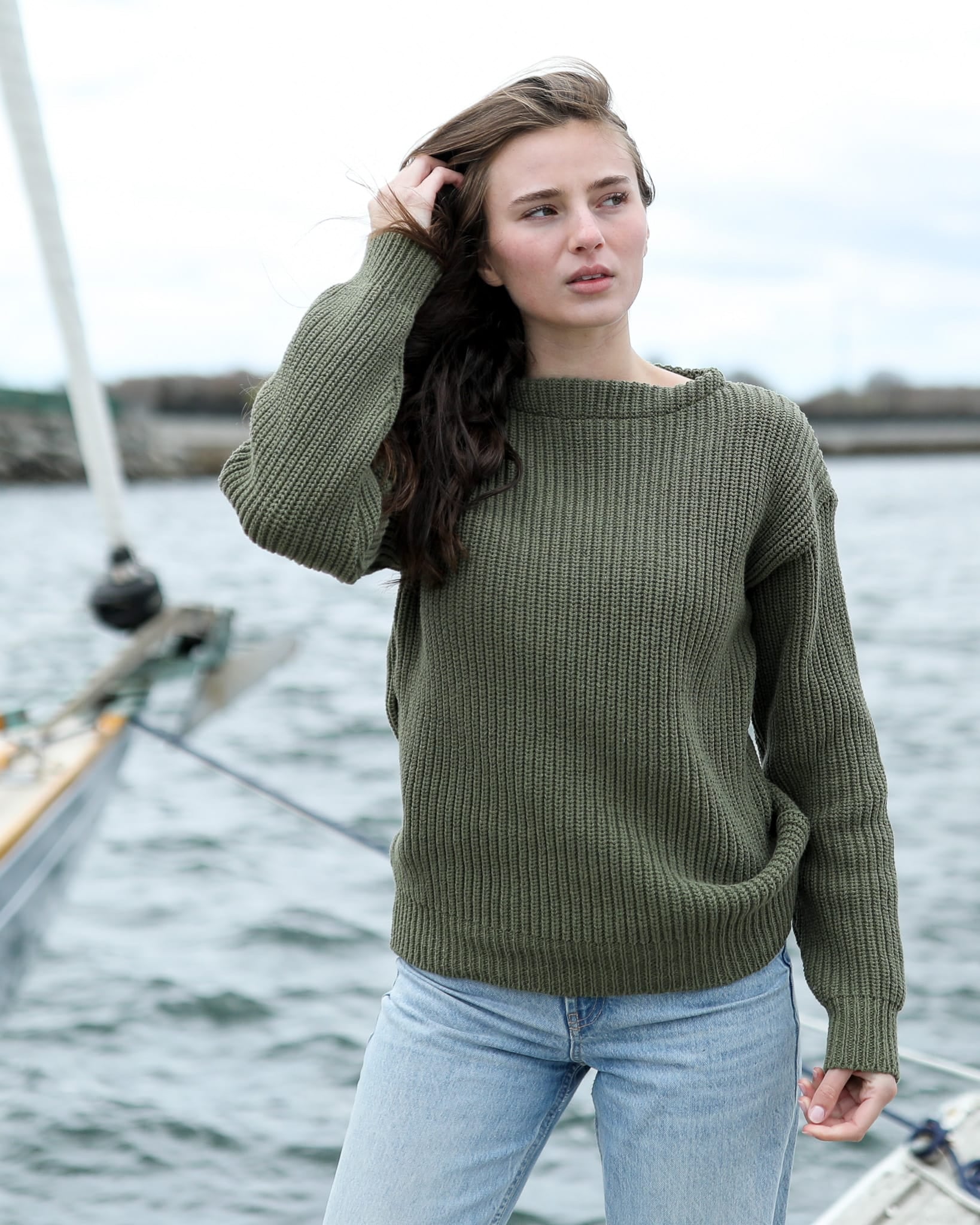 Olive boatneck sweater by the water