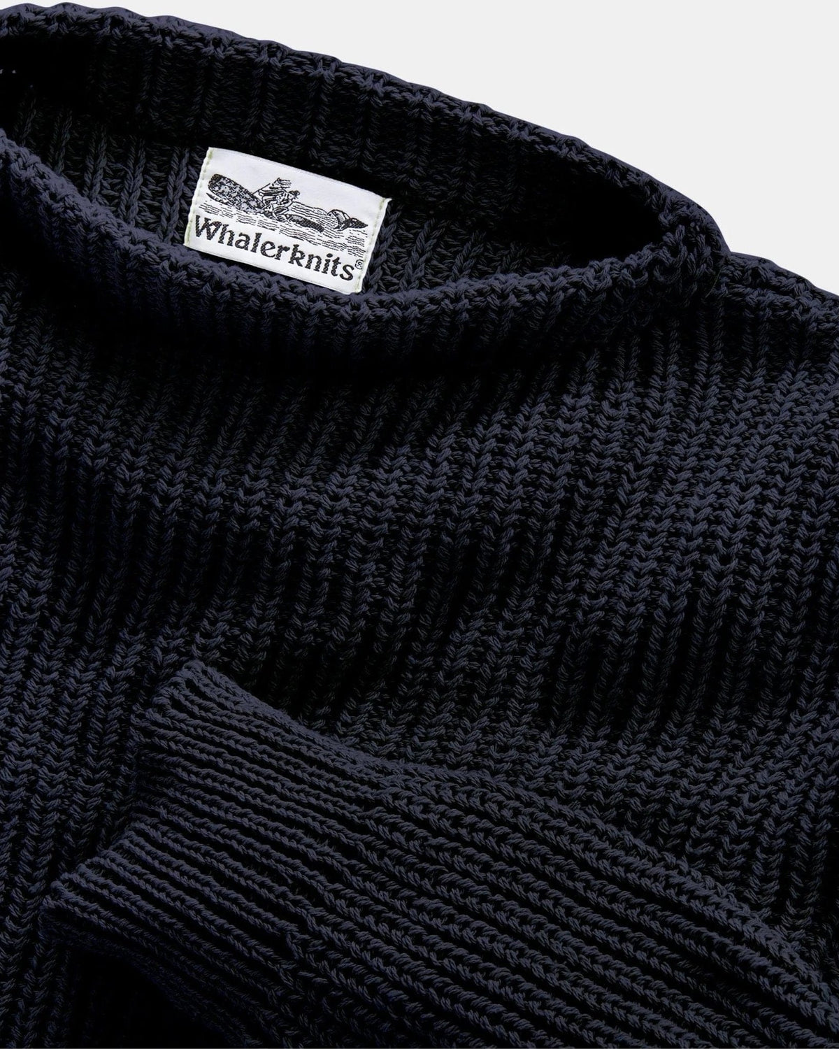 Whalerknits Newport Shaker Boatneck Sweater: Close-up of the black boat neckline, shaker-knit texture and label.