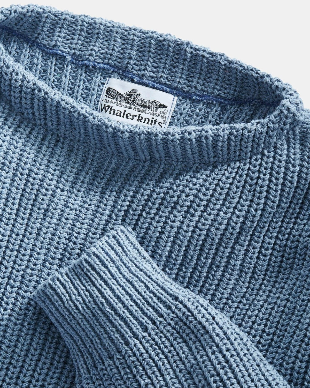 Whalerknits Newport Shaker Boatneck Sweater: Close-up of the blue boat neckline, ribbed cuff, knit texture and label.