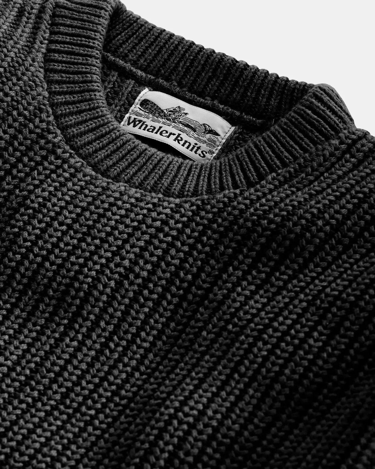 Whalerknits Newport Shaker Knit Crewneck Sweater: Close-up of the black crew neckline, textured knit and Whalerknits label.